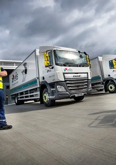 Men standing infont of Trucks