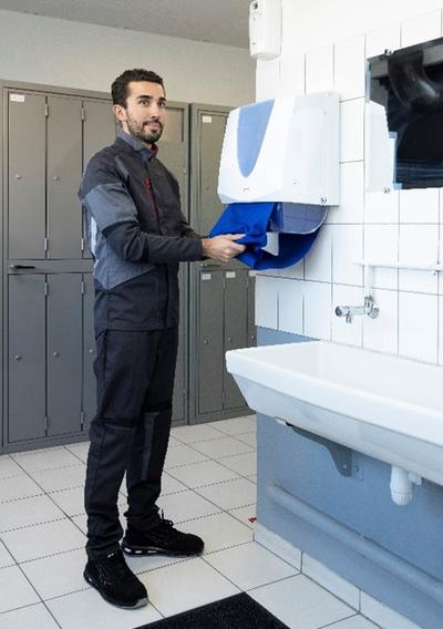 Worker in washroom cleaning hands